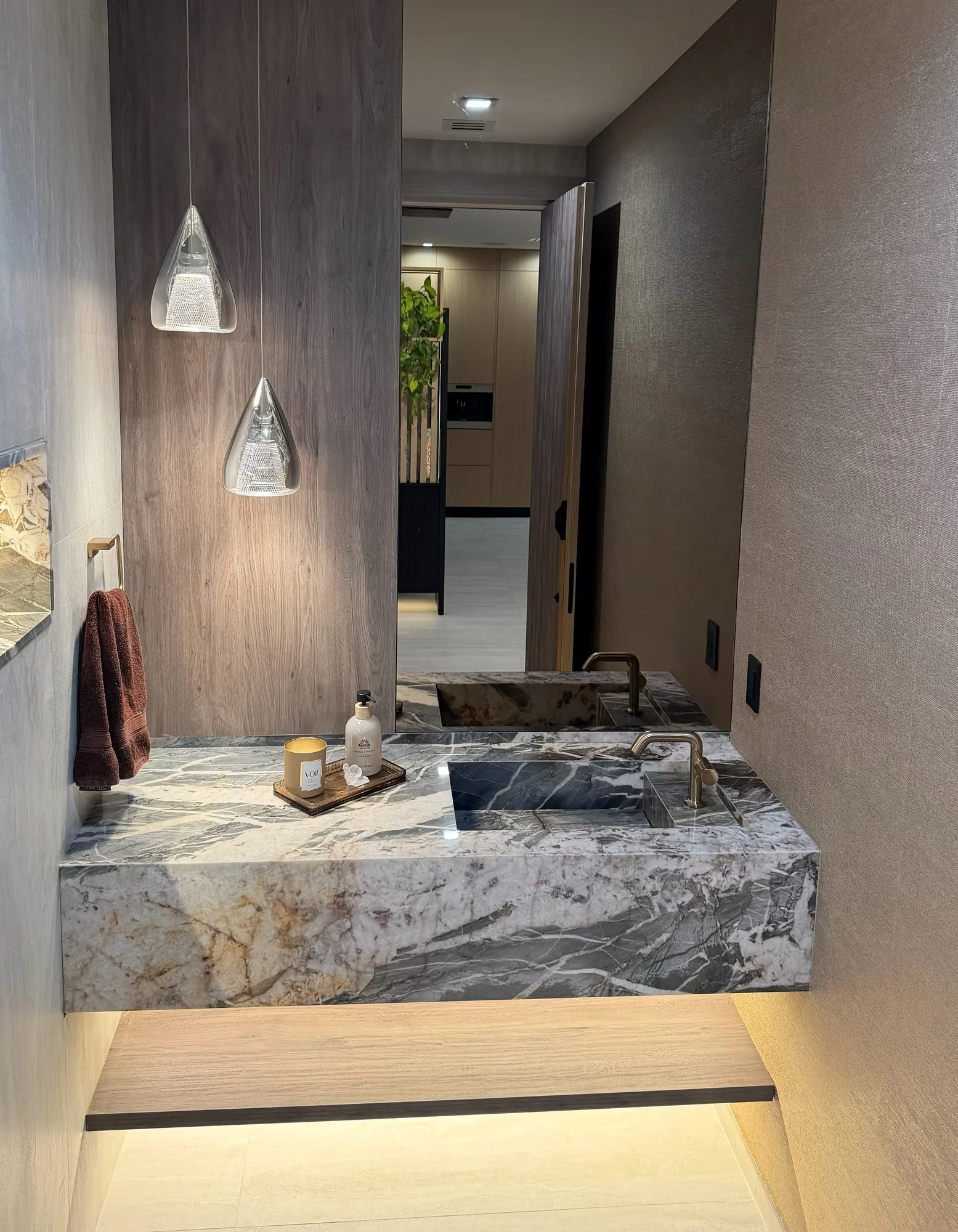 Powder room, lit stone vanity, finished